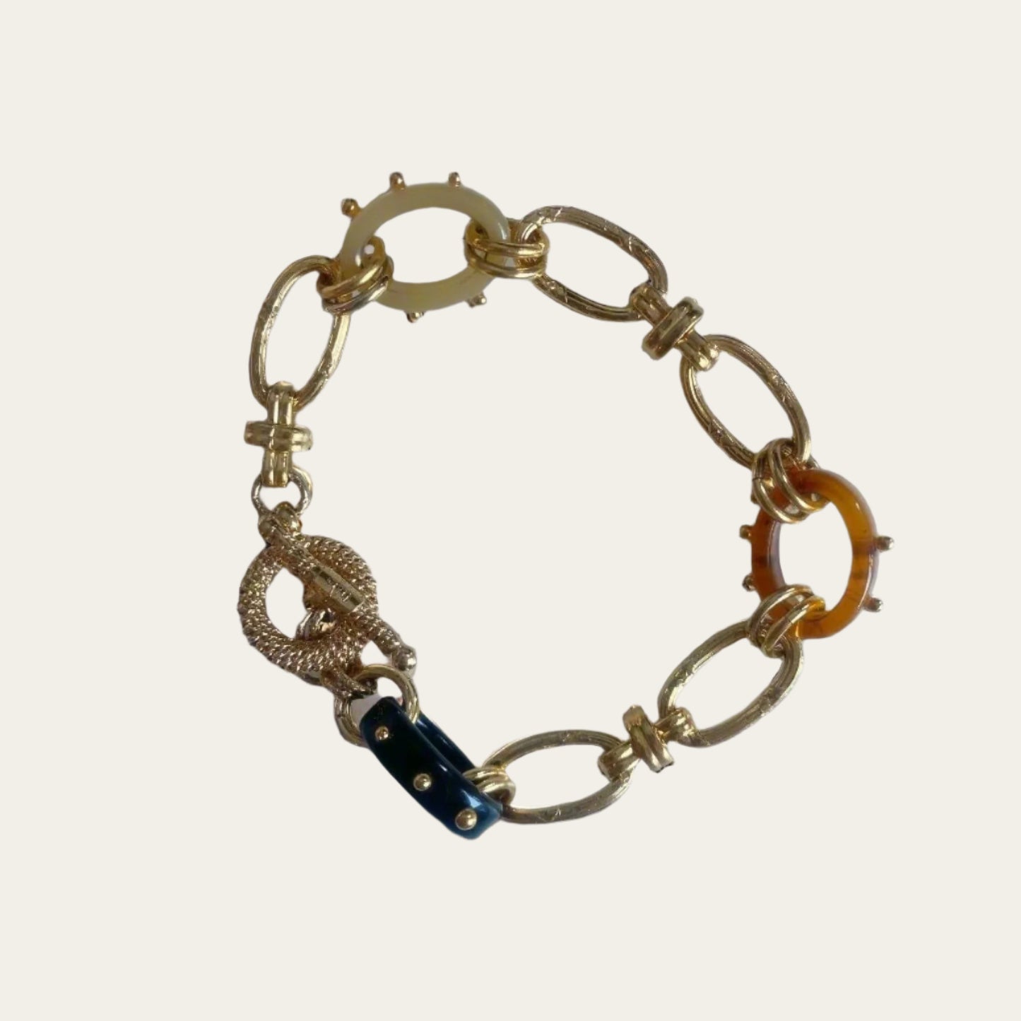 Bracelet from24K gold-plated material, Acetate link chunky bracelet on flat lay.