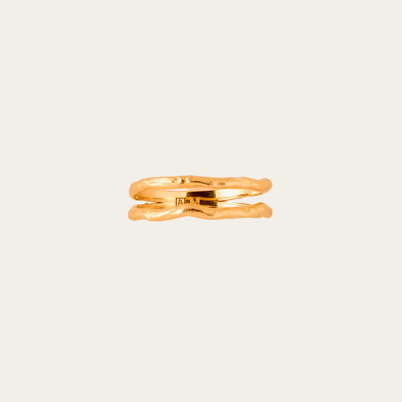Gold ring on a beige textured background