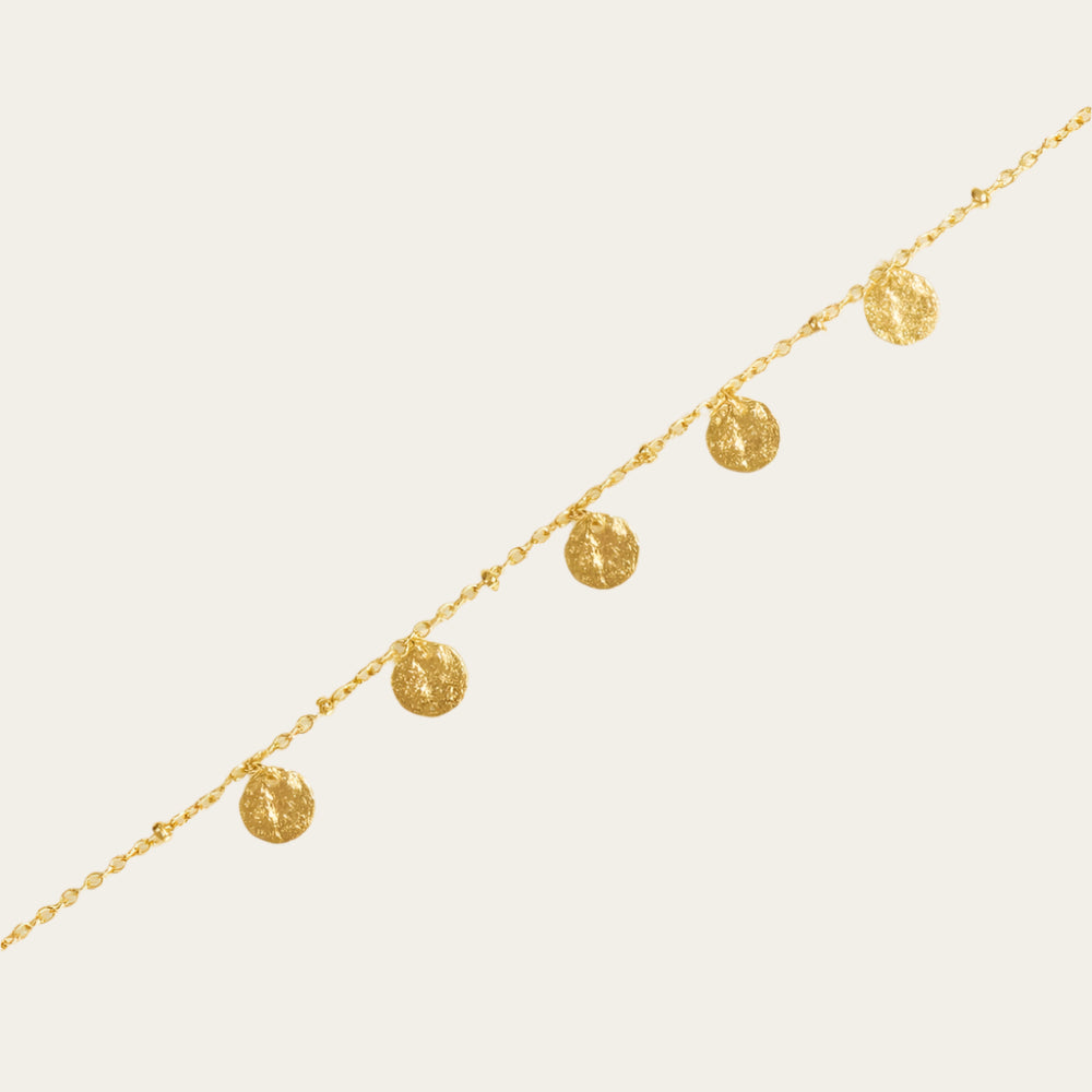 Alceste gold plated Bracelet on neutral flat lay surface