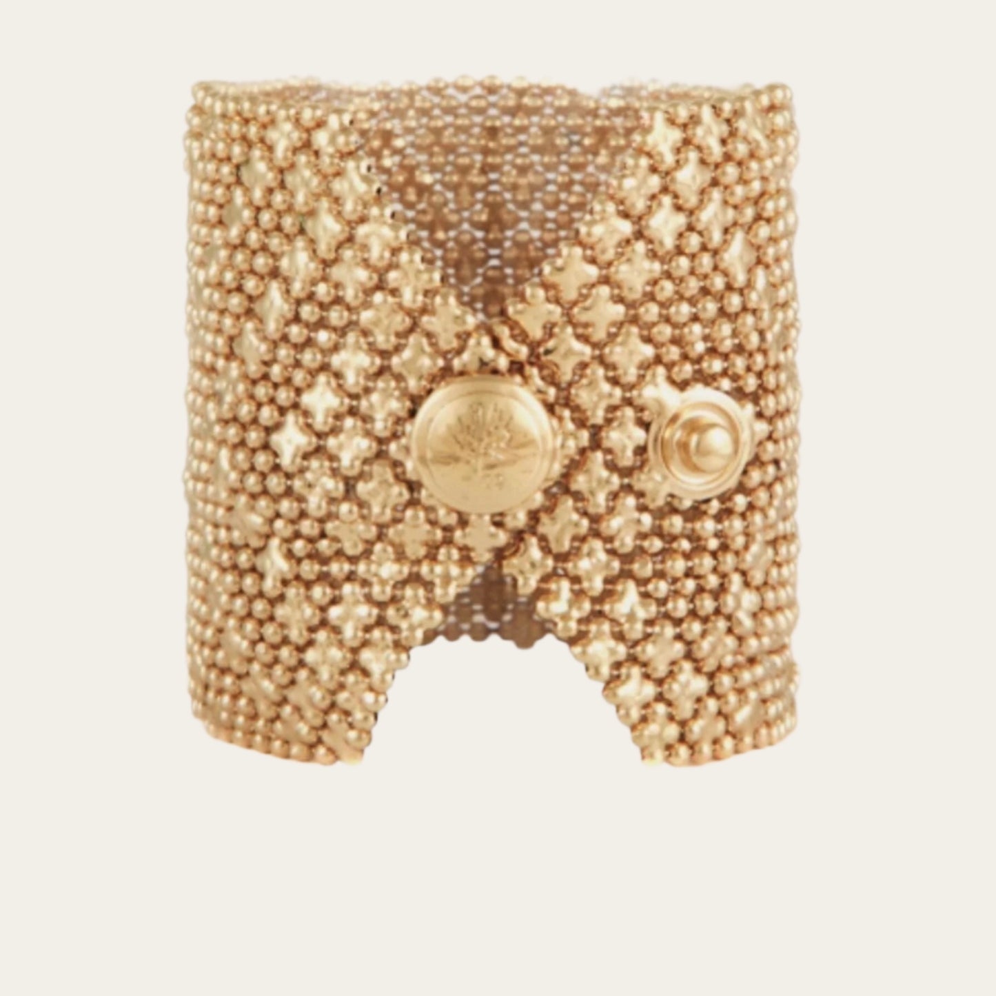 24k gold-plated cuff, adorned with multiple chains and star-shaped accents on neutral backround