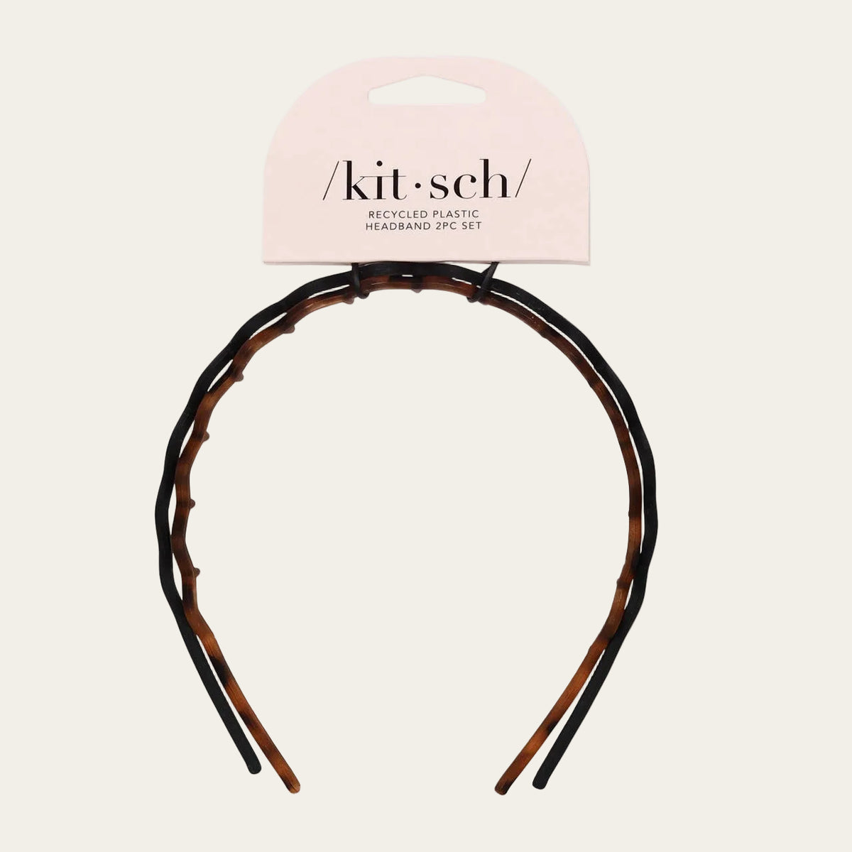 Tortoiseshell headband with 'kit-sch' packaging on a light gray background