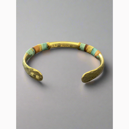 gold plated bangle with intricate detail available at The Artemis Edit