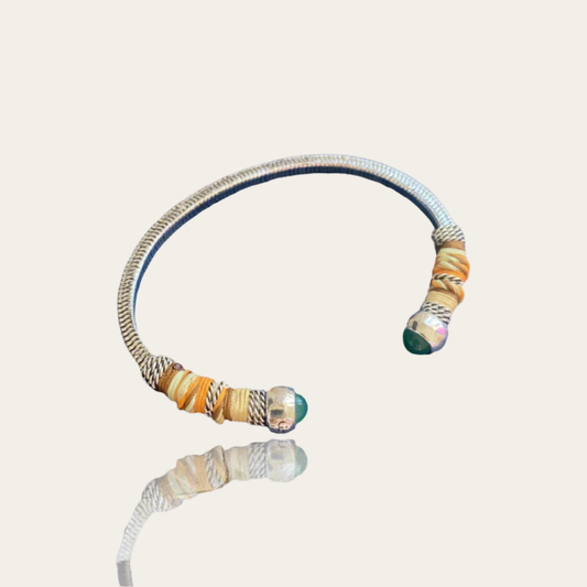 Silver bracelet with colorful beads on a beige background