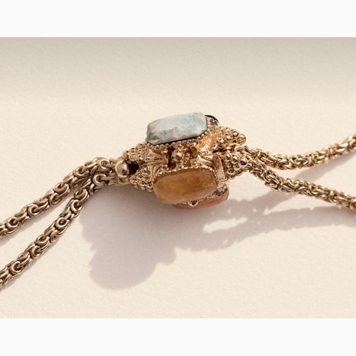 Talisman necklace in gold on neutral background