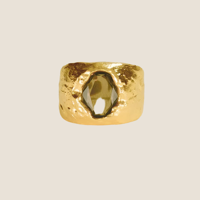 gold plated chunky, sculptural gold,green stone in centre, flat lay