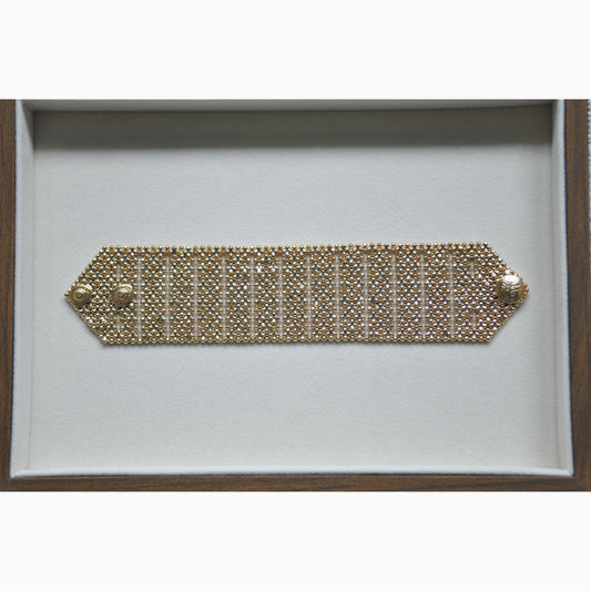 Gold bracelet on a white background