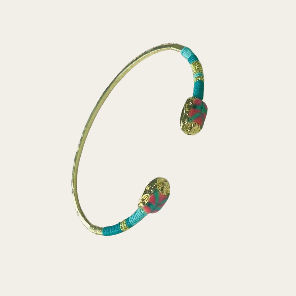 gold plated gas bijoux bangle in green and pink on neutral background