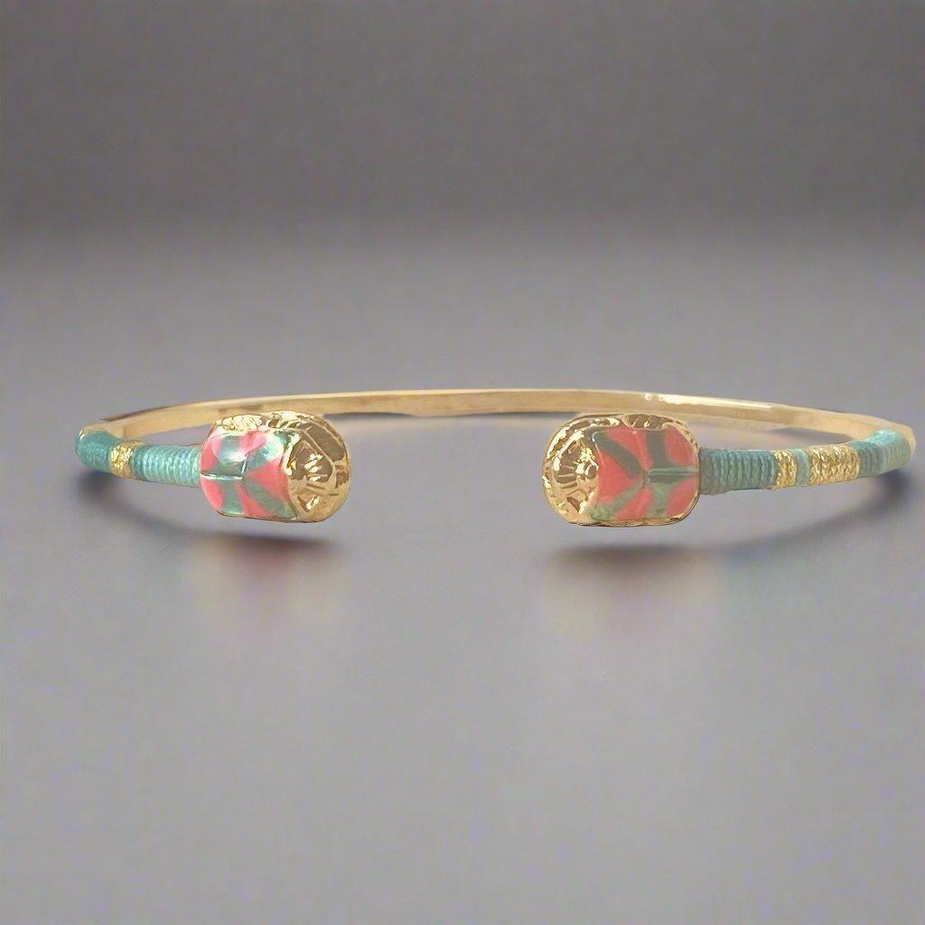 gas bijoux duality bangle pink & green on flat lay surface with light grey background