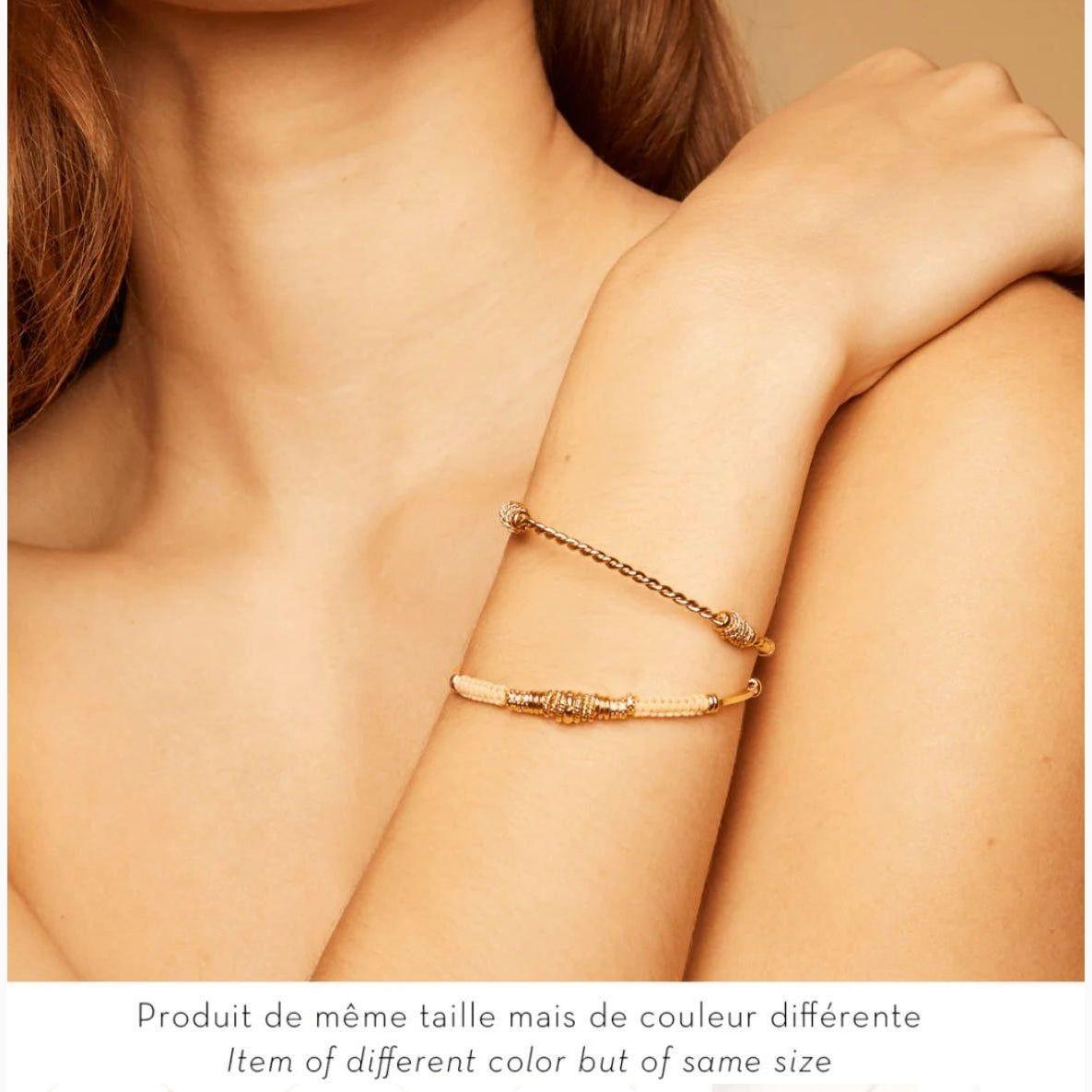 Gold Zizanie bracelet by Gas Bijoux worn on wrist, elegant twisted cuff styled with minimalist outfit