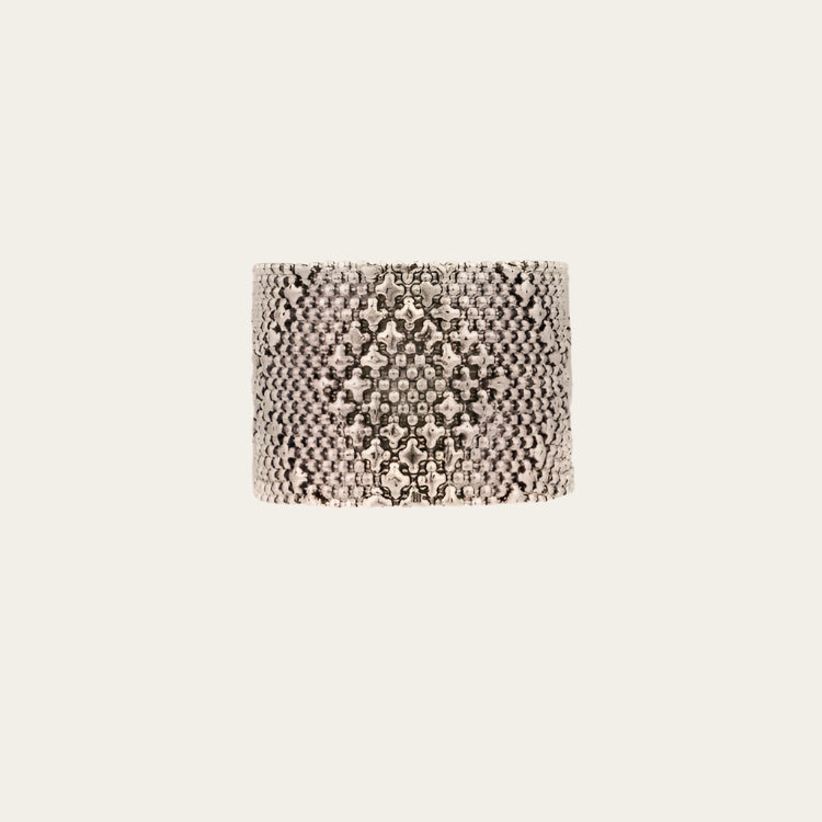 Textured silver bracelet on a white background
