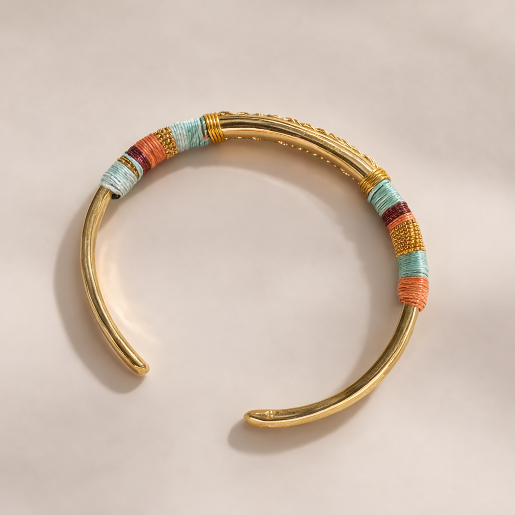 Gold bracelet with colorful beads on a beige background
