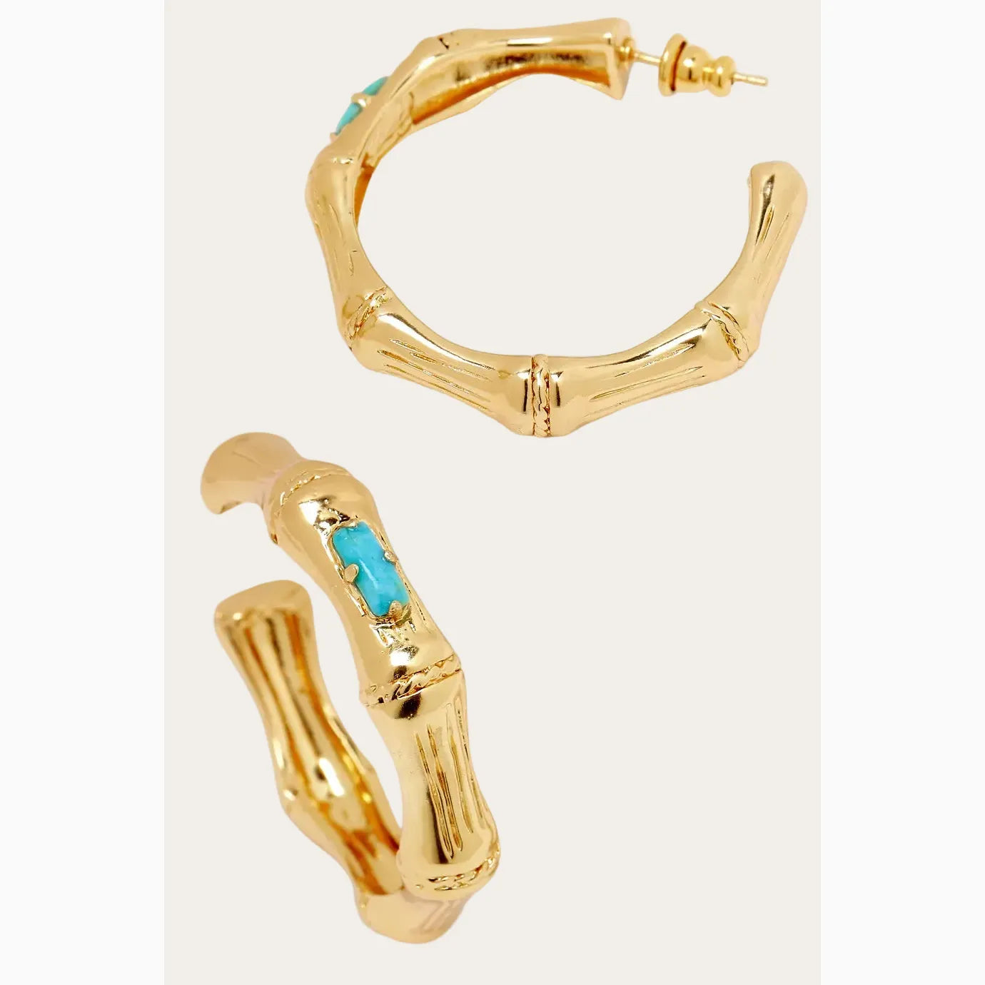 Gold hoop earrings with turquoise stones on a white background
