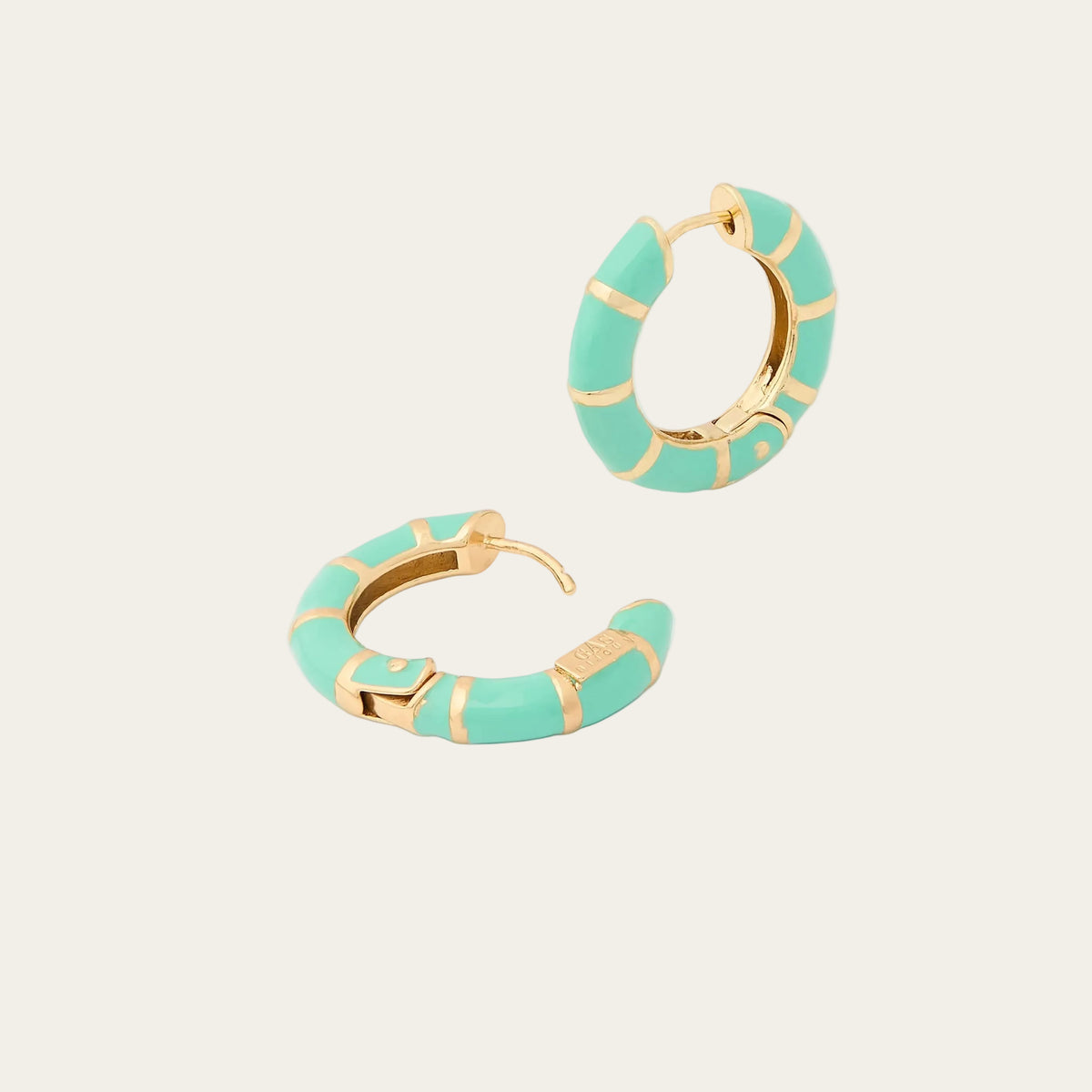 Pair of turquoise hoop earrings with gold accents on a white background