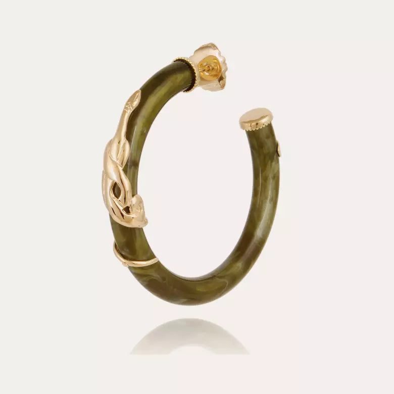 A gold and olive green earring hoop featuring a sculptural gold serpent motif on a smooth olive green curved body, set against a light off-white background.