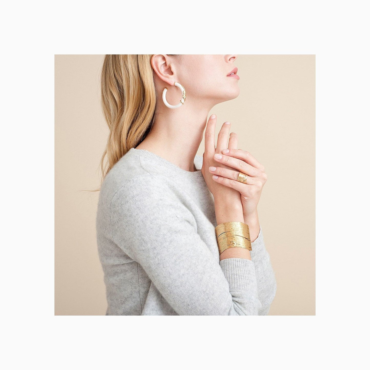 a woman wearing the gold plated wave bracelet with neutral clothing