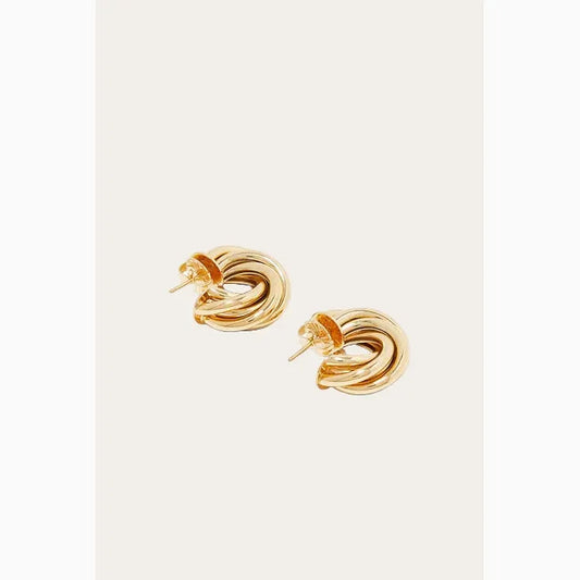 Pair of gold knot earrings on a white background