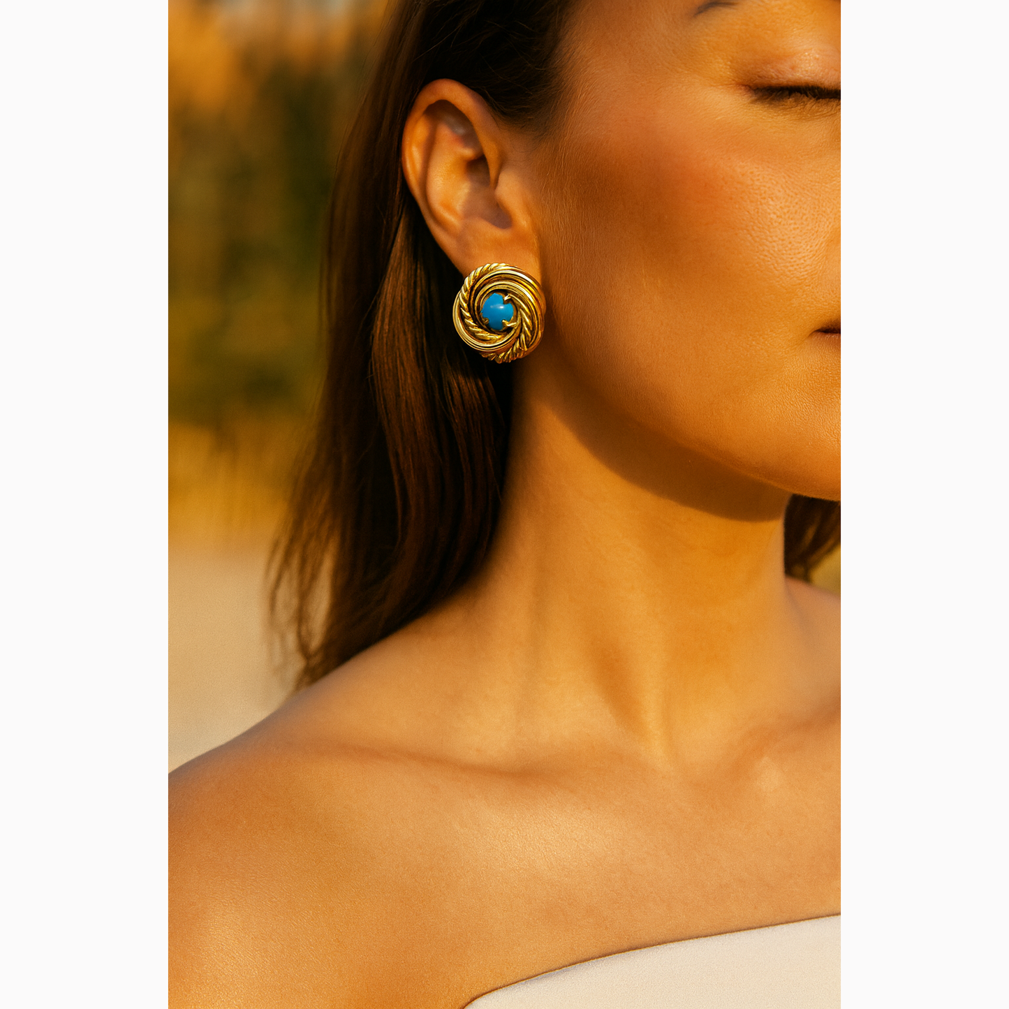 gold and turquoise earrings on woman at the artemis edit