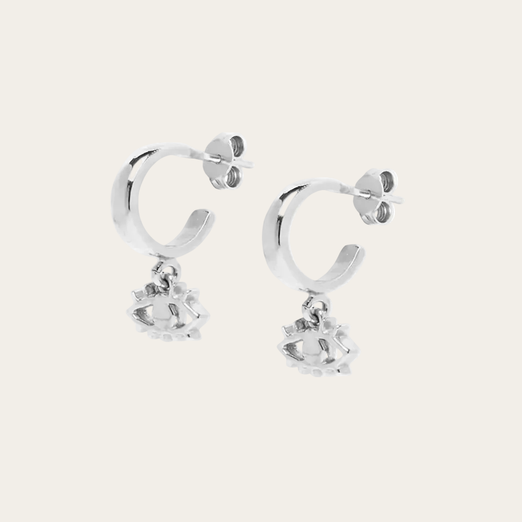 Silver hoop earrings with small round pendants on a white background