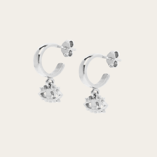 Silver hoop earrings with small round pendants on a white background
