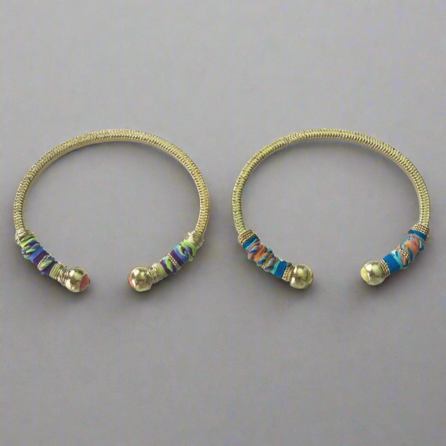 Gold plated bracelet embellished with tinted threads and gold plated chains. The bracelet is adorned with glass beads at ends. Adjustable size. Product Details Yellow Gold Plated Cotton Rope or all metal Width: 0,6 ; Circumference: 14,5 cm