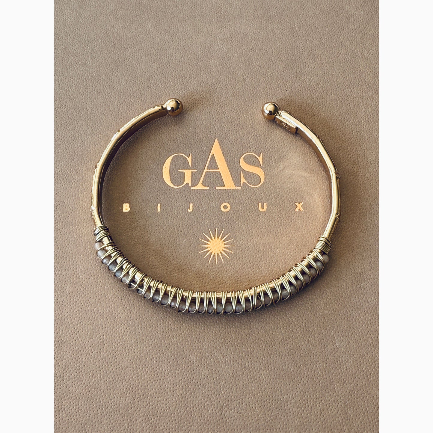 Bracelet on a 'GAS Bijoux' branded box with a beige background