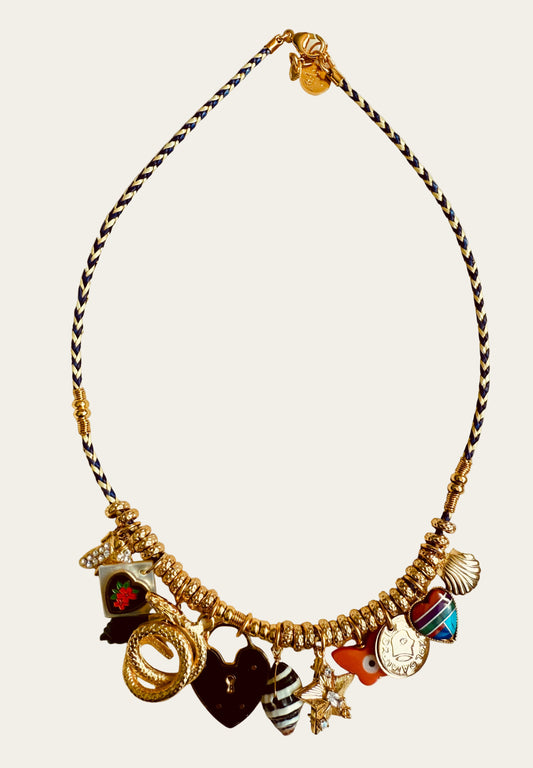 Necklace with various charms on a light green background