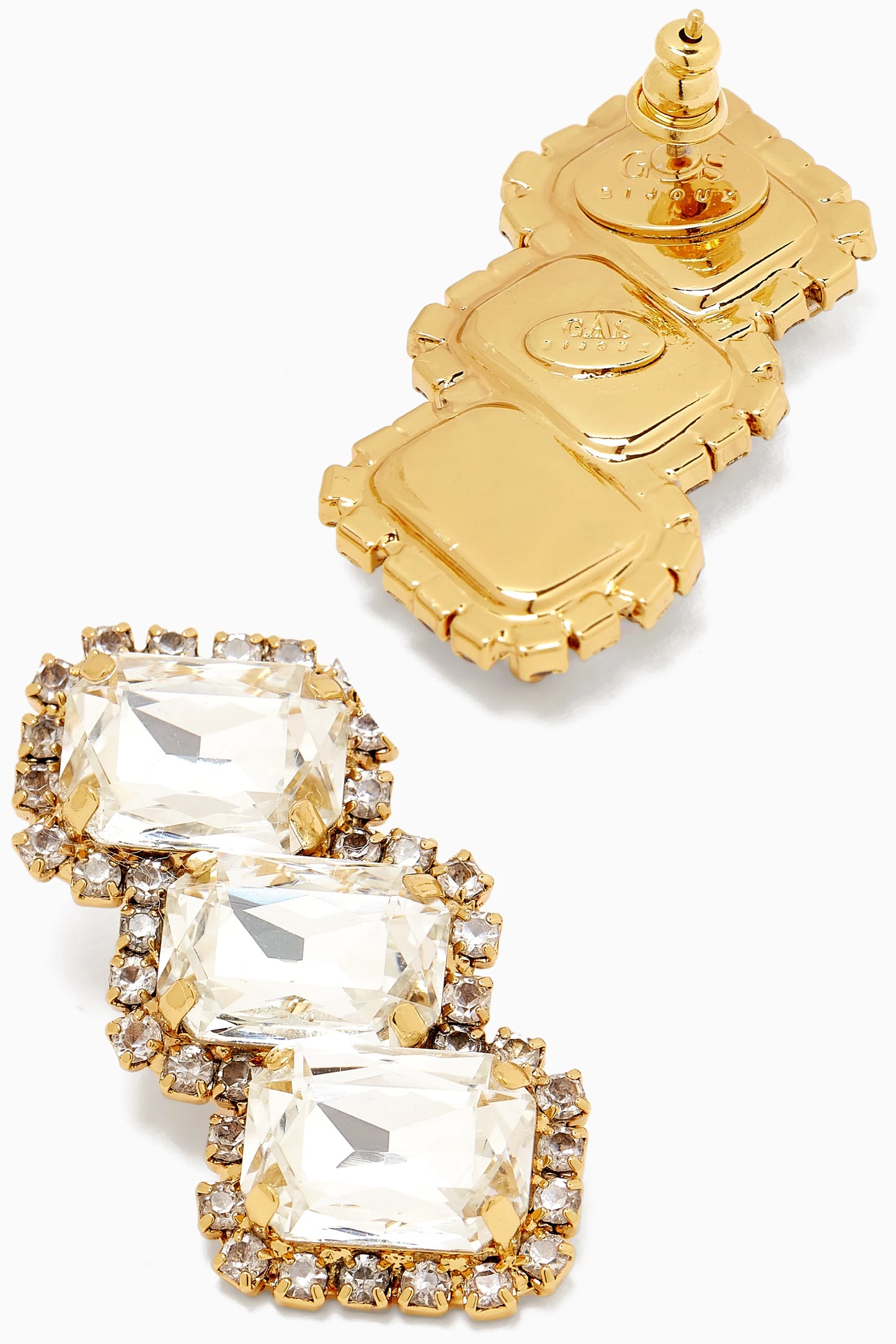 Gold and crystal earrings on a white background