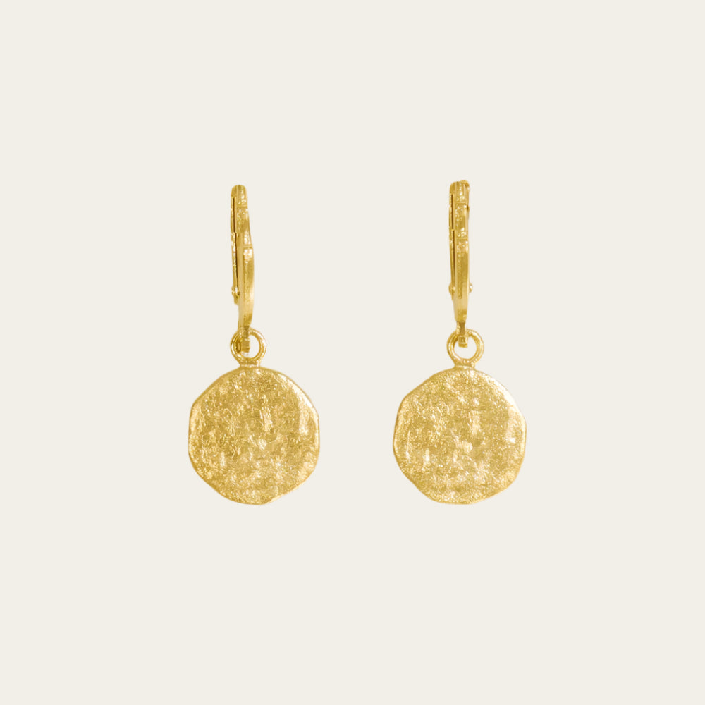 Agapee Luna earrings on neutral flat lay surface