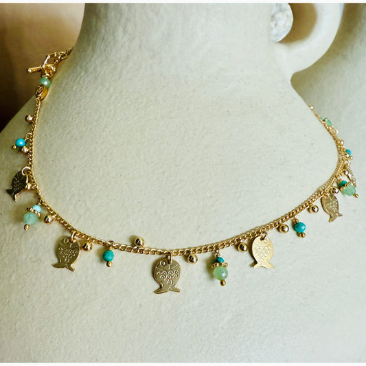 Gold necklace with fish charms on a mannequin bust