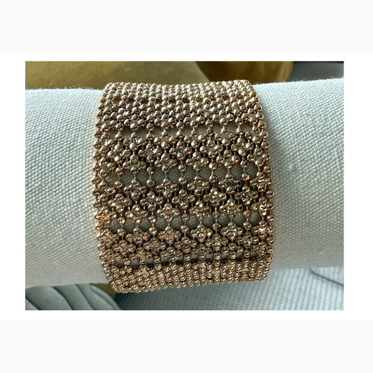 gold plated bracelet cuff on neutral background