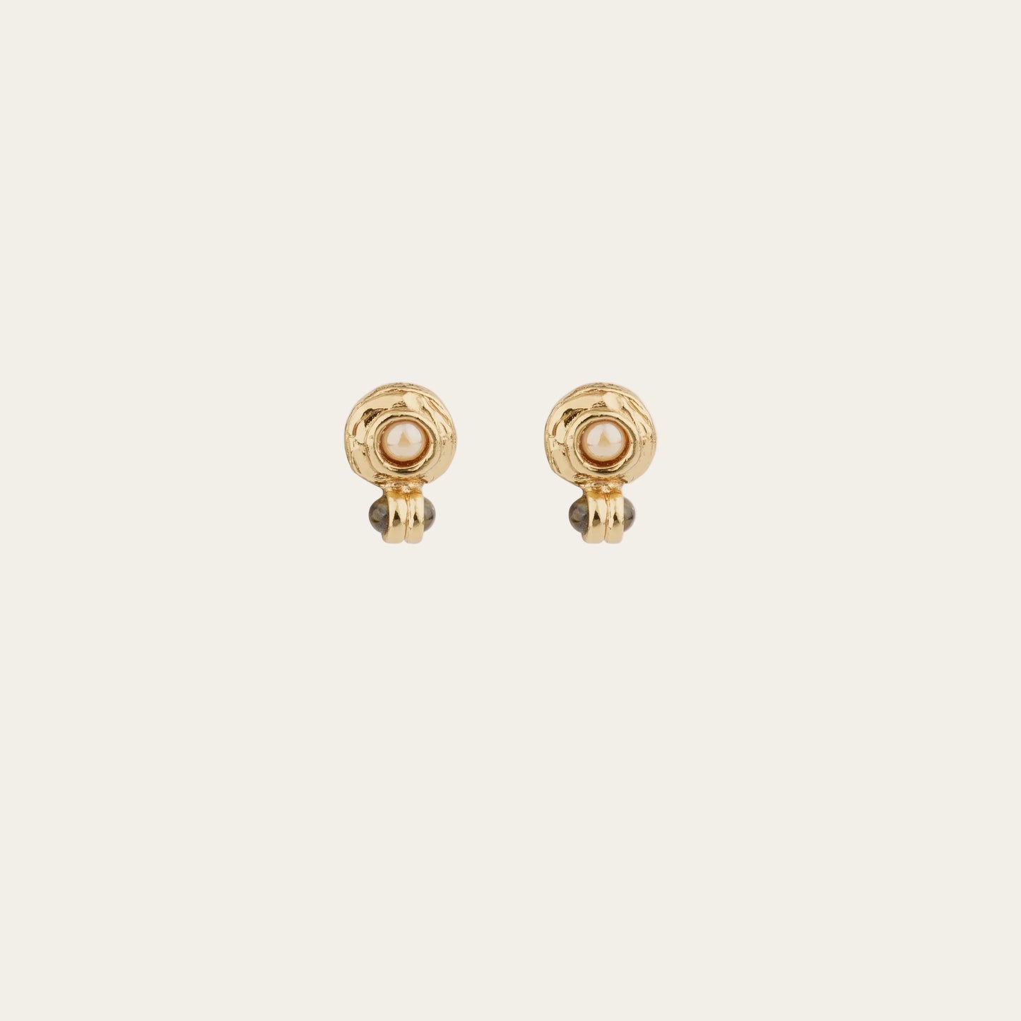 Two gold earrings with pearl on a white background