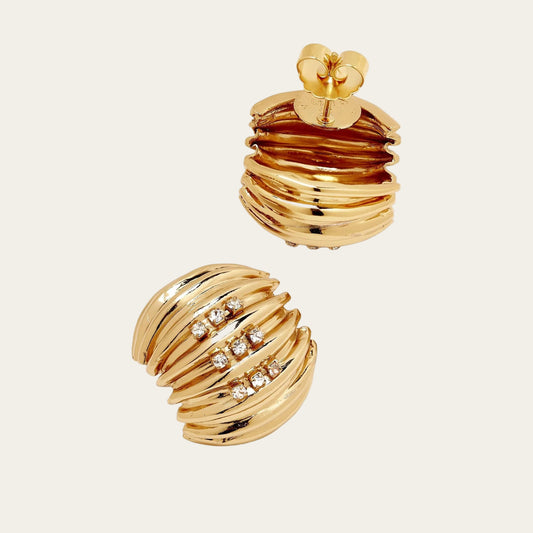Gold earrings with a textured design on a white background