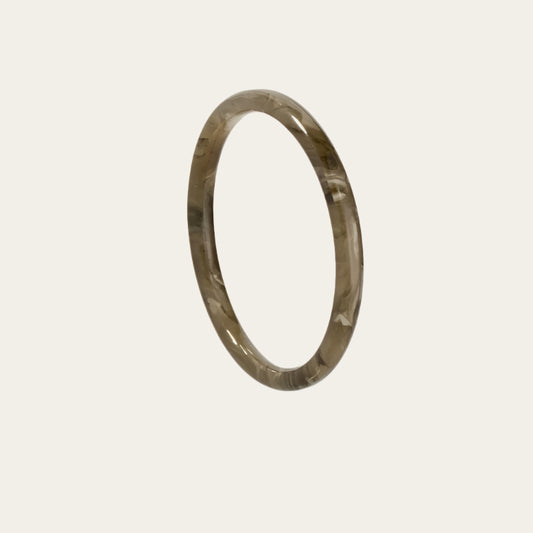 Acetate Gas Bijoux Bangle Grey on neutral flat lay available at The Artemis Edit