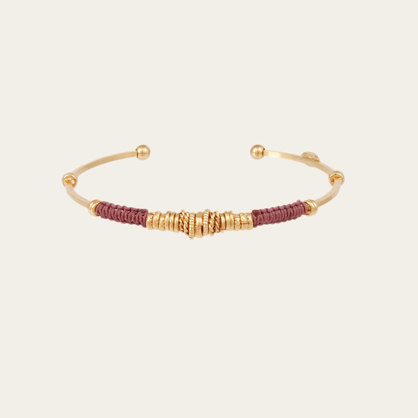 Gold and brown bracelet on a white background