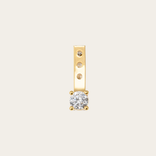 Gold earring with a diamond on a white background