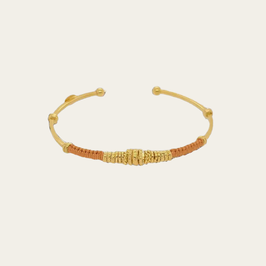 zizanie burnt orange bracelet on flat lay neutral surface