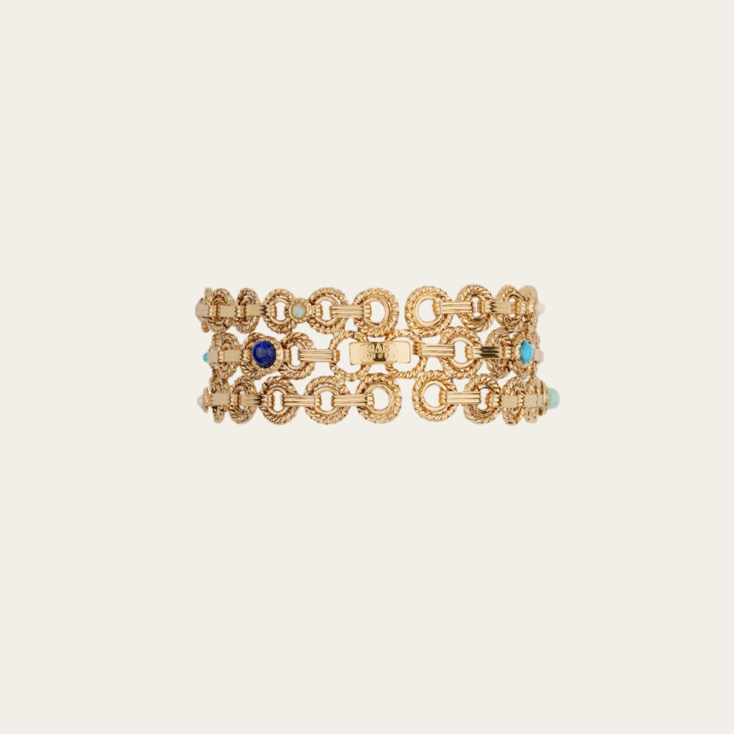Gold chain bracelet with blue and turquoise stones on a beige background