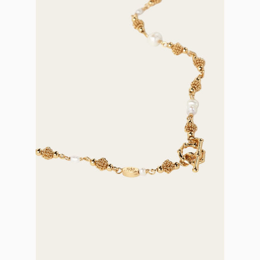 Gold necklace with pearls on a white background