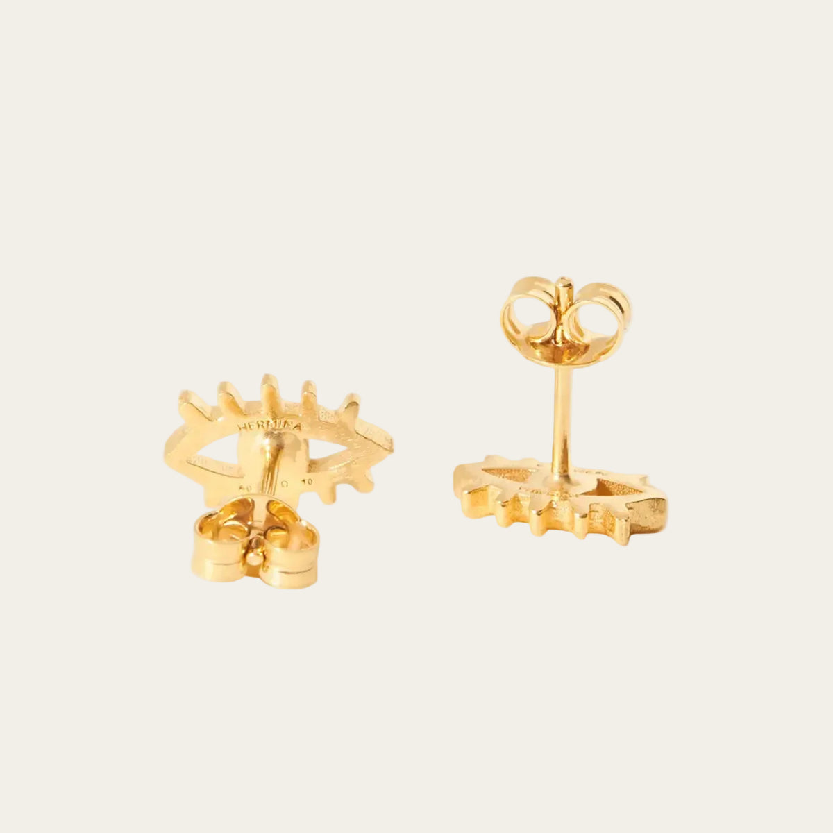 Eye shaped earrings on a light gray background