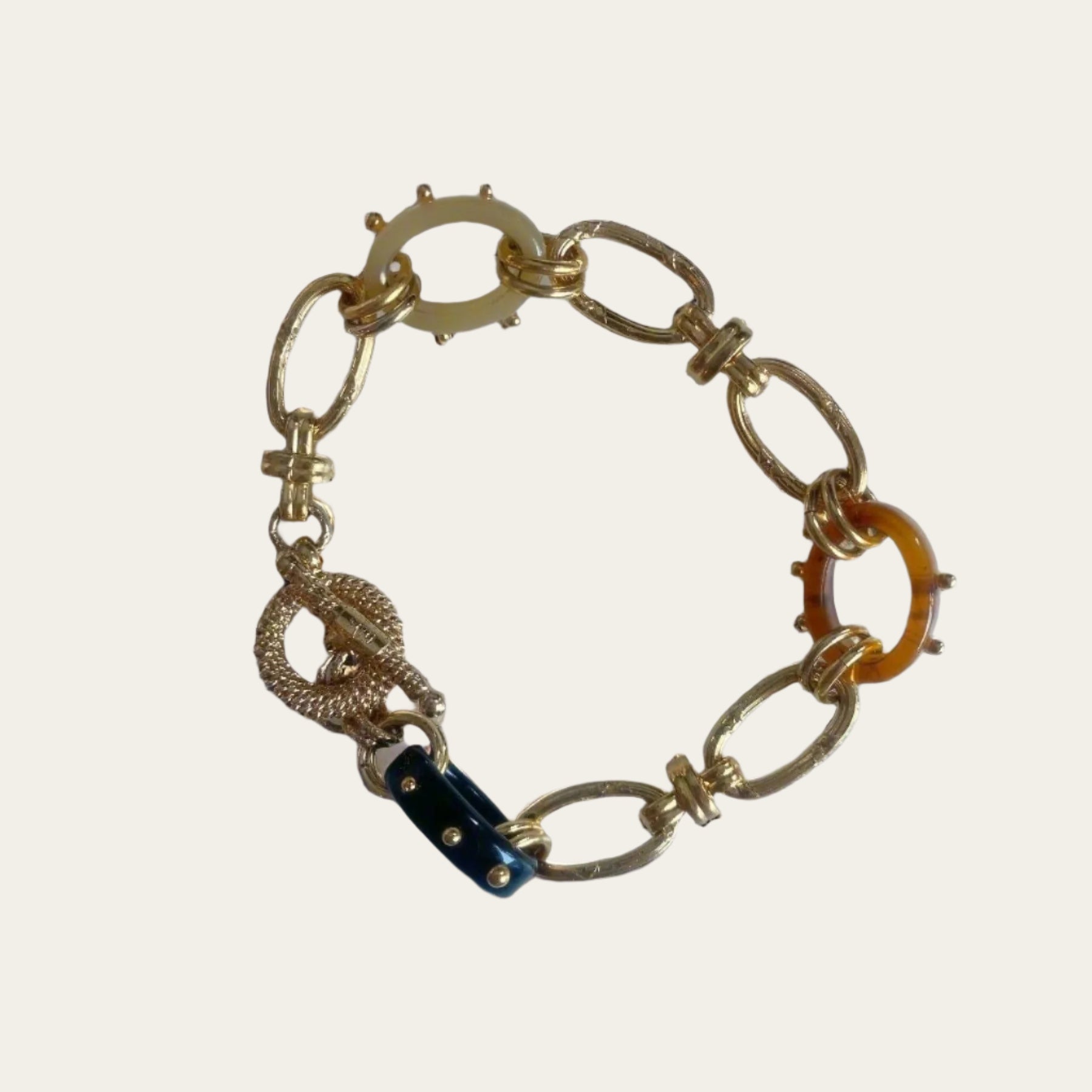 Bracelet from24K gold-plated material,  Acetate link chunky bracelet on flat lay.