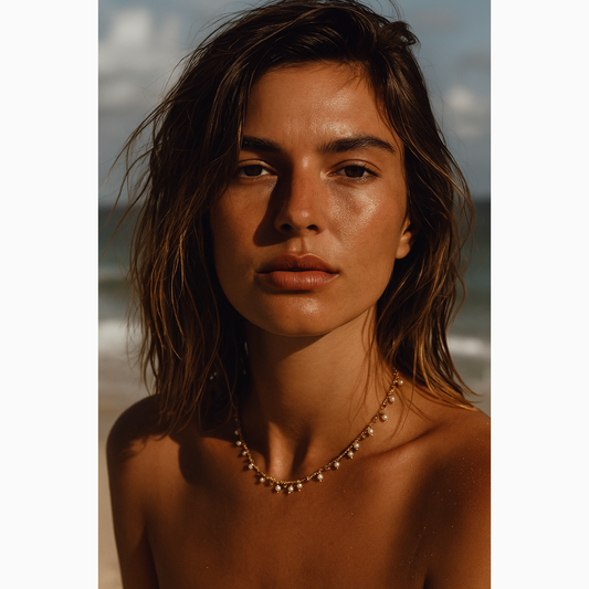 Woman with a gold and pearl necklace on a beach