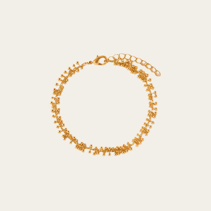 Gold bracelet on a beige background