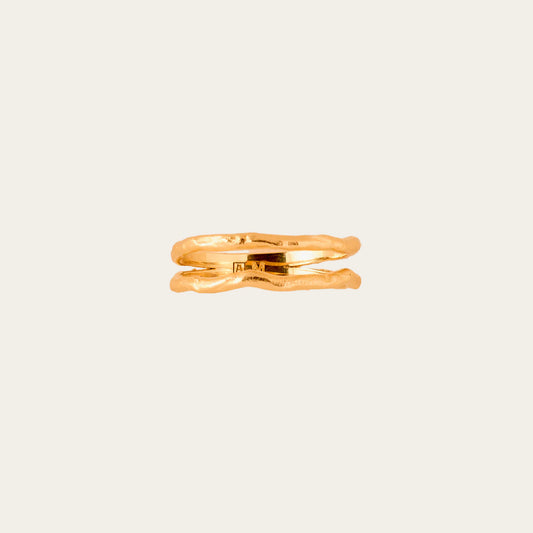 Gold ring on a beige textured background
