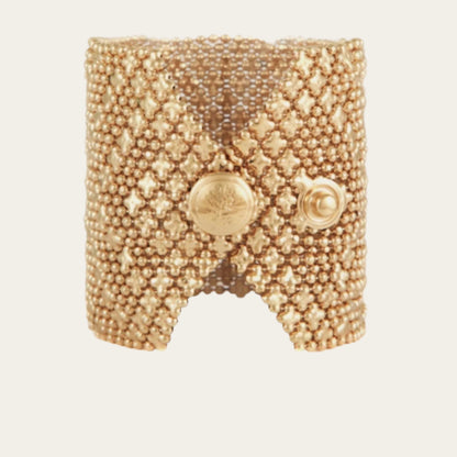  24k gold-plated cuff, adorned with multiple chains and star-shaped accents on neutral backround