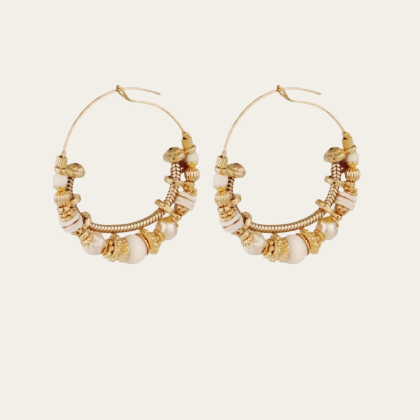 gold-plated earrings adorned with sparkling gemstones and golden beads. 