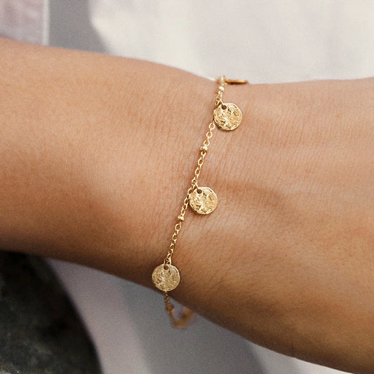 Gold plated Alceste Bracelet close up image on model hand