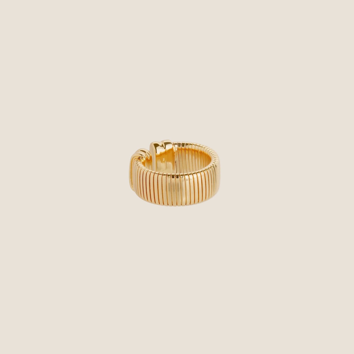 gold chunky ring on cream background