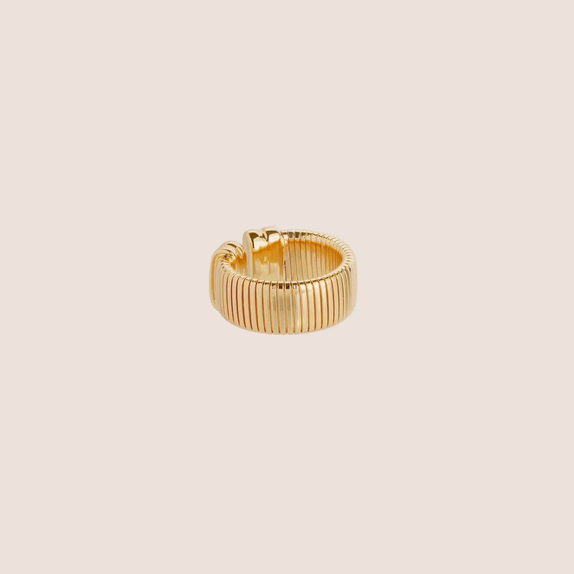 gold chunky ring on cream background