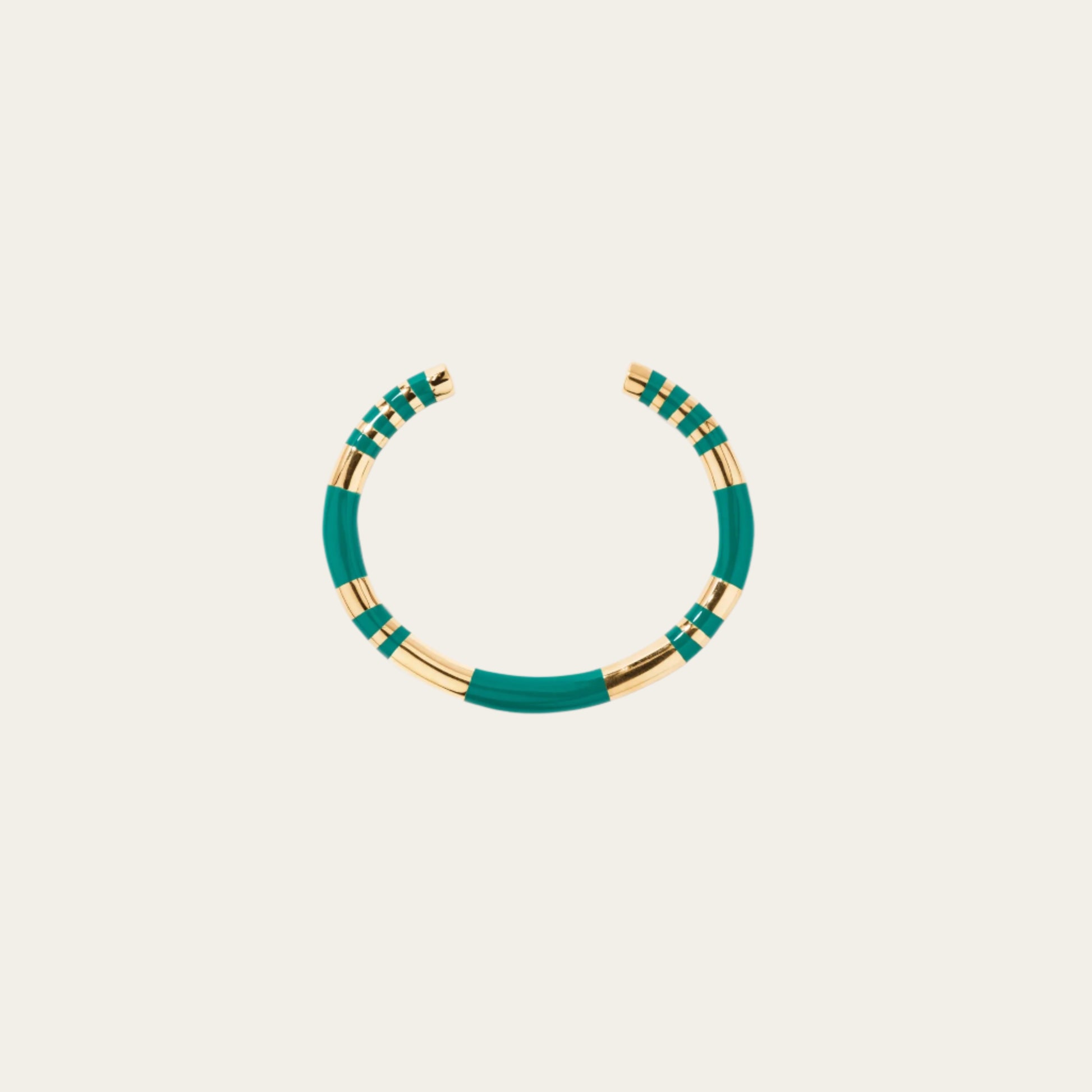 Aurelie Bidermann Emerald Positano Bangle on neutral flat lay surface