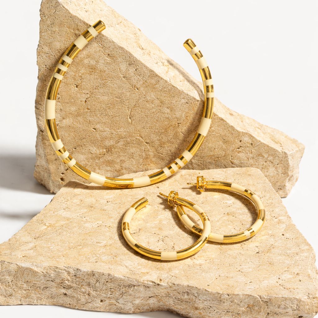 gold and white hoops on travertine background